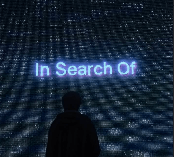 In Search Of spelled out across an LED wall.