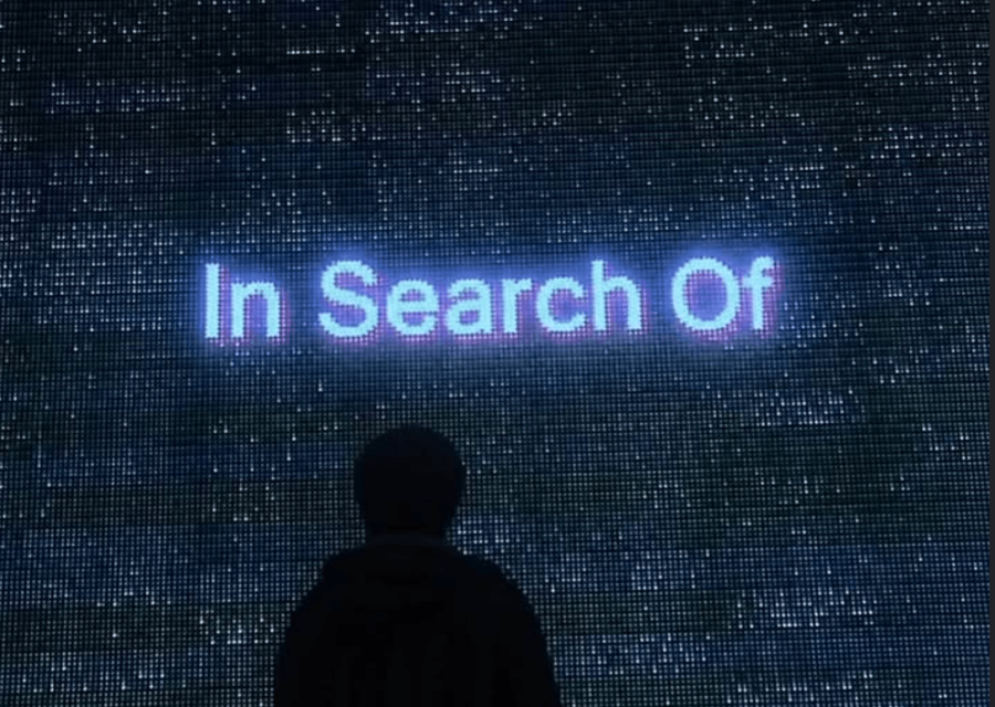 In Search Of spelled out across an LED wall.